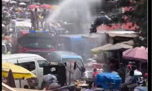 Fire service personnel spraying water into the air at CMB