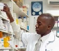 Pharmacist takes drug from shelf.          File photo.