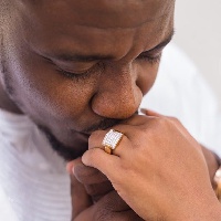 John Dumelo kisses hand of his wife