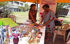 A participant examining items at the Trade Fair