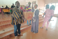 A beneficiary receiving a sewing machine