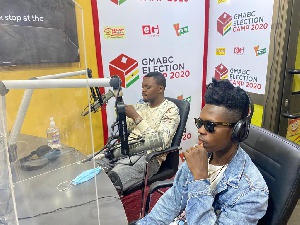 Strongman Burner (in spectacles) at a media interview