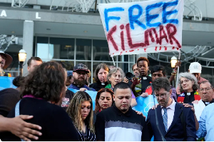 Kilmar Abrego Garcia, centre, is flanked by his lawyer and wife at a protest
