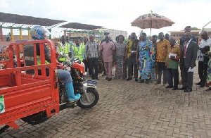 Kofi Addah, Osei Assibey Antwi and other dignitaries inspecting the branded tricycles