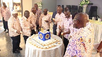 Some past and present board members and directors of ECG enjoying a piece of the anniversary cake