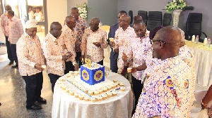 Some past and present board members and directors of ECG enjoying a piece of the anniversary cake