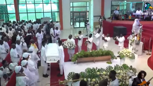 Pallbearers lifting the remains of the late KODA, whiles musicians lead the procession