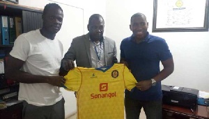 Inusah Mustapha with a club official and his agent