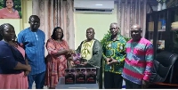 Opanin Kwabena Mensah presents the books to the principal of ABETICOE