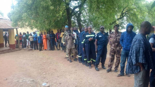 Some security officers queue at a voting centre