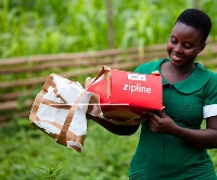 A nurse receives a zipline drone delivery