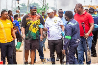 NPA boss Godwin Kudzo Tameklo (in white) confers with Deputy Minister John Dumelo