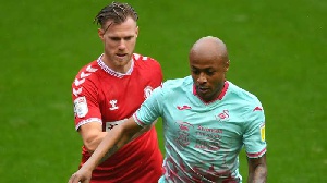 Andre Dede Ayew holds off an opponent