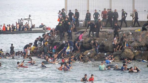 Migrants started to return to Morocco after thousands entered Spain's Ceuta