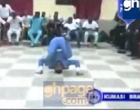 Bishop Daniel Obinim roiling on the floor amidst cheers from the church members