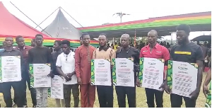 A photo of the 13 residents who were honoured by the president