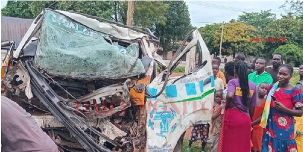 Bystanders dear the wreckage of an a minivan involved in a road crash recently