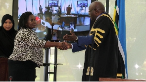 Kenya’s EA Community Affairs Cabinet Secretary shakes hands with EALA  Speaker Joseph Ntakirutimana