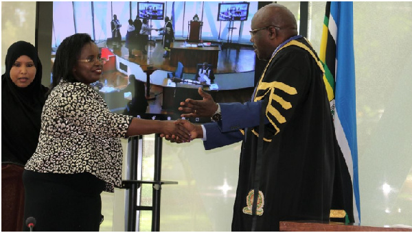 Kenya’s EA Community Affairs Cabinet Secretary shakes hands with EALA  Speaker Joseph Ntakirutimana