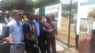 Gyan inspecting banners of the project with Robert Coleman
