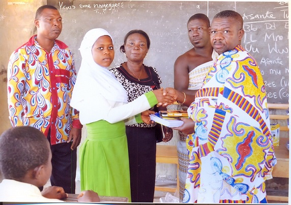 A pupil of the Islamic School receiving some of the items from Nana Kwanfo II