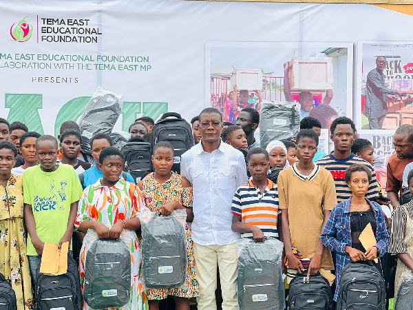 Isaac Ashai Odamtten in a photograph with some of the beneficiaries