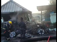 Fire officers and police at the accident scene trying to retrieve the burnt bodies