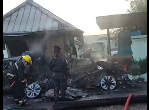 Fire officers and police at the accident scene trying to retrieve the burnt bodies