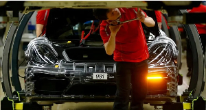 A man is seen working or a a car