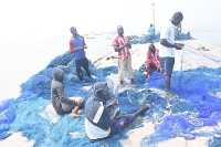 Some of the fishermen mending their nets at James Town
