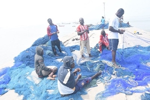 Fishermen working on their net