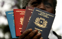 A Somali immigration official holds up new passports