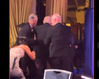 Trump (M) being escorted by security officials