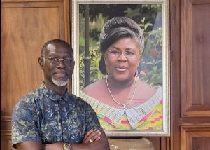 Edward Kufuor poses with his mother's photo