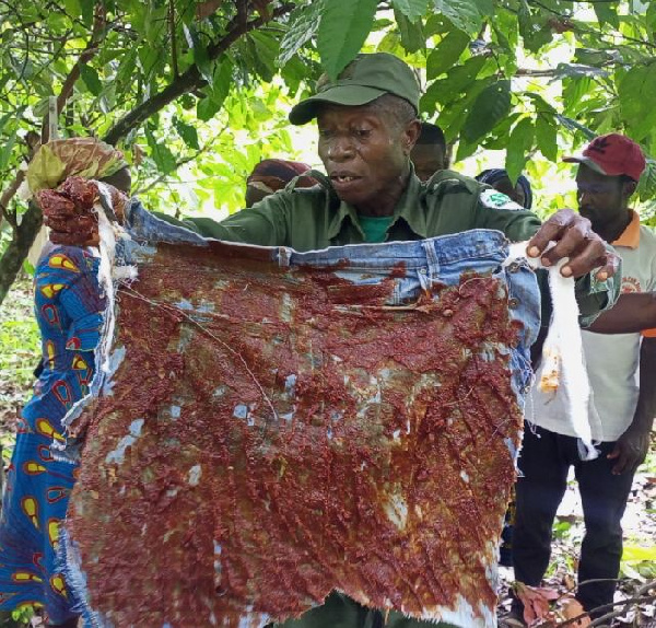 A man holding a chili-pepper grease fence