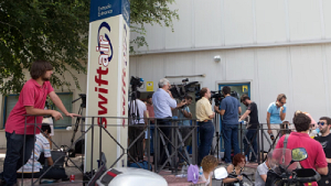 Journalists wait for news outside the Spanish Swiftair airline office in Madrid