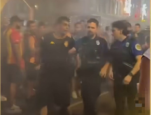 Police escorting the Esperance fan (L) after the arrest
