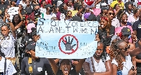 A Kenyan woman holding a placard