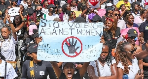 A Kenyan woman holding a placard
