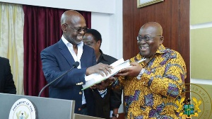 Ghana President Nana Addo (right) receives plans documents from Dr Botchway and Dr Thompson