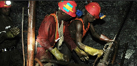 Gold miners are photographed underground on Feb. 20, 2014, during a press tour in gold mine