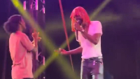 Black Sherif performs with sign language fan on stage