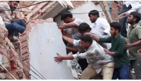 Rescuers race to free people trapped after building collapse in Delhi