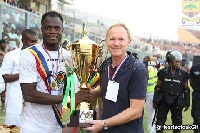 Inusah Musah and Frank Nuttal holding the trophy