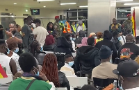 A picture of returnees seated at the airport