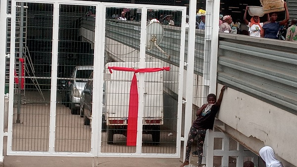 A red band tied around a gate