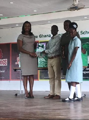 Nadia Bruce-Muller presents books to Mr. Quarmson while Ms Asare and Miss Kyei-Mensah look on