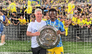 Henry Addo (R) celebrating with the trophy with a team member