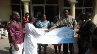 Stanbic Bank Chief Executive, Alhassan Andani hands cheque to RPSB Centre