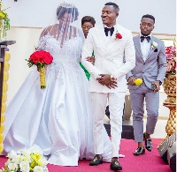 Henry Gyan walk down the aisle with his wife
